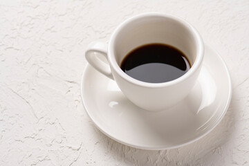 close-up shot of cup of coffee on white tabletop