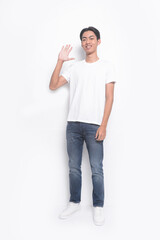 Full body portrait of a young man in a white t-shirt. jeans with stop gesture , casual fashion.