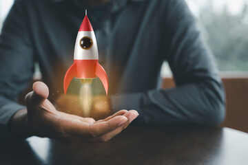 Business startup. Businessman holding rocket 3D icon on hand, rocket takes off launching and soar...