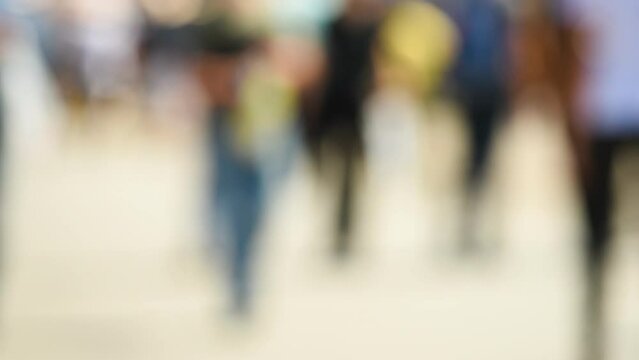 Crowd of anonymous people on the street in summer, tourist pedestrians walking in the city, selective focus