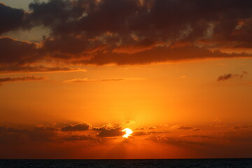 Fototapeta premium The sun sets below the horizon on the Mediterranean Sea in northern Israel.