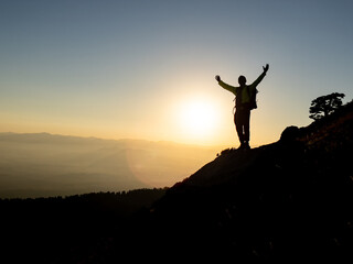 silhouette of mountaineer in summit mountains