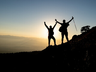 silhouette of mountaineers in summit mountains