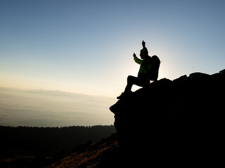 mountaineer's resting position on the rock in the summit mountains