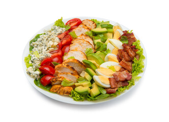 Cobb salad of romain lettuce, slices bacon, avocado, chicken, tomato, eggs, blue cheese, in a white salad bowl isolated on white background. - 526973705