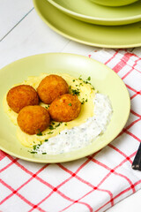 Chicken patties or fish cakes fried in breadcrumbs with potato and souse