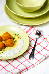Chicken patties or fish cakes fried in breadcrumbs with potato and souse