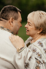 Fototapeta premium Happy seniors taking a walk in the park on sunny day. Old senior family concept