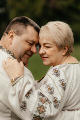 Fototapeta premium Happy seniors taking a walk in the park on sunny day. Old senior family concept