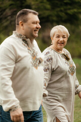 Beautiful senior couple kissing in autumn. Happy old age of a family who has lived a long life together. Copy space. Beautiful senior couple sitting in autumn.