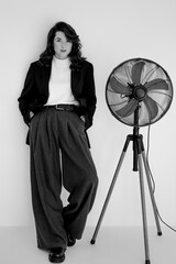 black and white portrait of young stylish woman wearing wide pants and jacket