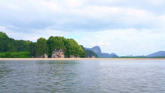 Krabi Island in Thailand.
pov. on a boat sailing in the middle of the sea among beautiful nature and green mountains on an island in the middle of the sea.4k