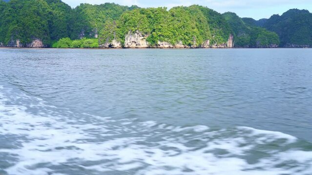 Krabi Island in Thailand.
pov. on a boat sailing in the middle of the sea among beautiful nature and green mountains on an island in the middle of the sea.4k