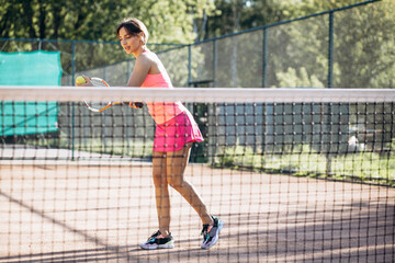 Young woman tennis player at the court
