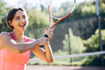 Young woman tennis player at the court