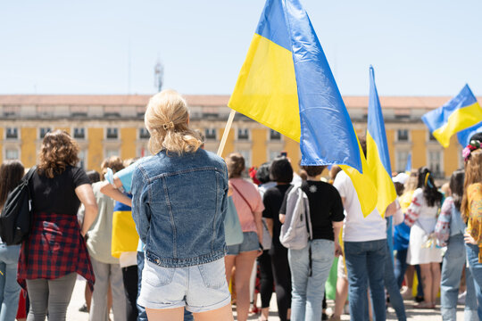 Portugal, Lisbon April 2022: The demonstration on Commerce Square in support of Ukraine and against the Russian aggression. Protesters against Russia's war Many people with Ukrainian flags.