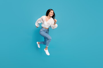 Fototapeta na wymiar Full body profile portrait of sportive energetic lady running jump isolated on blue color background