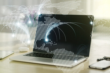 Double exposure of abstract digital world map with connections on laptop background, research and strategy concept