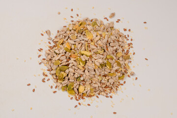 Mix of seeds for a salad. A pile of mixed seeds isolated on white background.