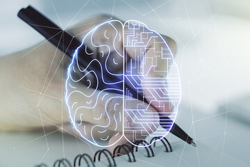 Double exposure of creative human brain microcircuit with man hand writing in notepad on...
