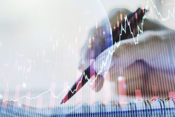 Abstract creative financial graph with world map and with woman hand writing in diary on background, financial and trading concept. Multiexposure