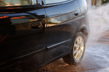 close-up of someone washing a car