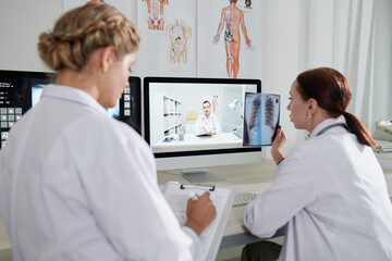 Medical Worker Discussing X-ray Image