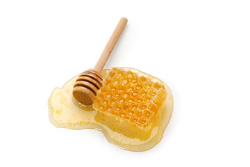 Honey in a honeycomb with wooden stick, dipper isolated on white background. Natural bee product.