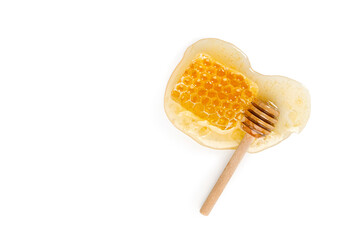Honeycomb with wooden honey stick, dipper isolated on white background. Natural bee product. Top view.