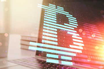 Double exposure of creative Bitcoin symbol with modern laptop on background. Cryptocurrency concept
