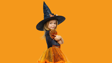 Happy child girl in witch costume. Halloween party time.