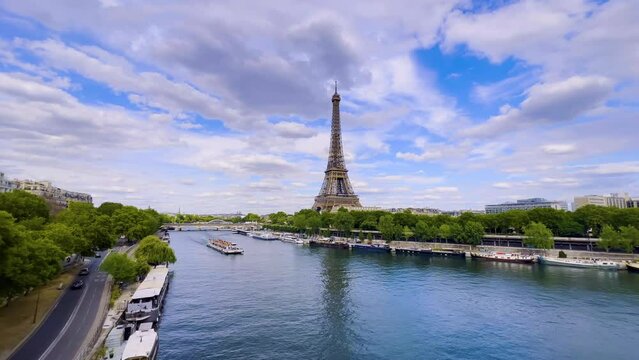  Aerial drone distant sunset view of Tour Eiffel Tower and Seine River bridge traffic cars driving, Paris city attractions, France 
