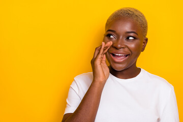 Photo of adorable charming lady look empty space arm palm near mouth tell whisper secret message...