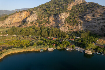 Fototapeta na wymiar See Lycian Rock Tombs, one of the ancient architectural wonders of Turkey, carved into the cliffs facing the town of Dalyan. Mugla-Turkey