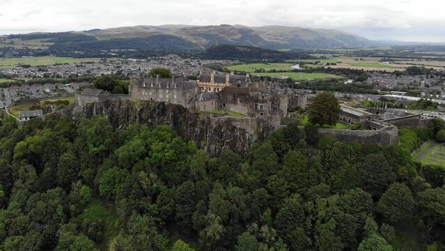Drone shot of Stirling Castle in Scotland with the Wallace monument in the distant background.