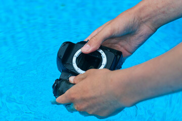 Washing dirty dslr camera in water. Crazy photographer poorly cleans the camera sensor with water....