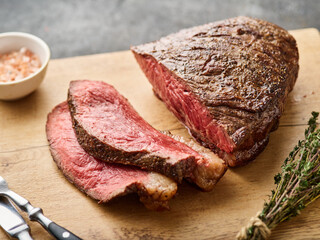 Grilled ramp cap steak on a cutting board. Barbecue Grilled rump cap or brazilian picanha beef meat...