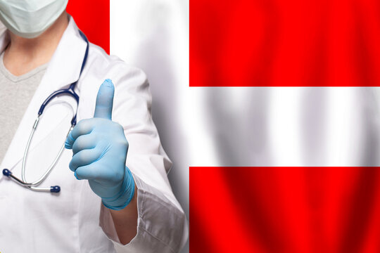 Danish doctor's hand showing thumb up positive gesture on flag of Denmark background