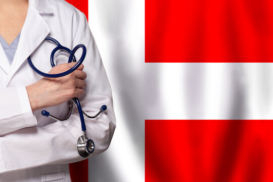 Danish medicine and healthcare concept. Doctor close up against flag of Denmark background