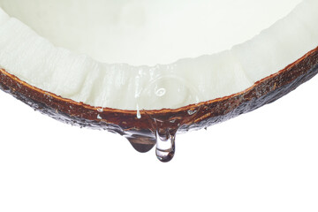Macro shot of coconut oil dripping out. Piece of coconut with essential oil or coconut water...