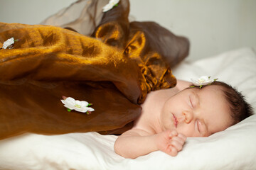 Cute little baby girl in golden dress sleeping at home