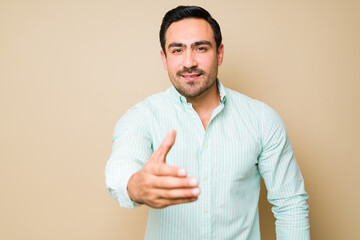 Portrait of a happy young man shaking hands during a meeting