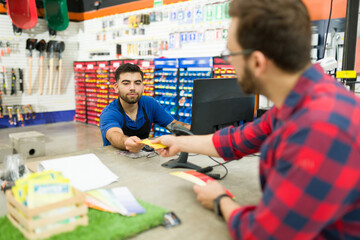 Male customer paying for his shopping at the hardware store