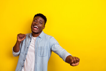 Photo of cheerful positive guy dancing actively floor night club isolated vibrant yellow color background
