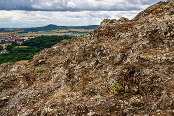 Volcanic rock with plants on top of hill Zebin, town Jicin, Czechia.