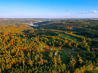 Aerial panorama of woodland landscape with dam Orlik on horizon in summer sunset. - obrazy, fototapety, plakaty