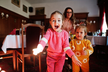 Little sisters having fun in restaurant.