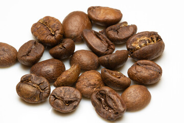 heap of medium Roasted coffee beans on white background. macro photo