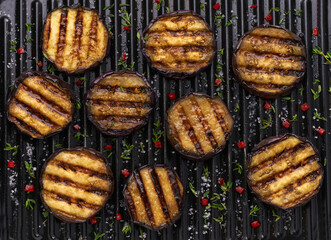 sliced grilled eggplant , with chilli pepper and spices, top view. Ideas for barbecues and grill parties.