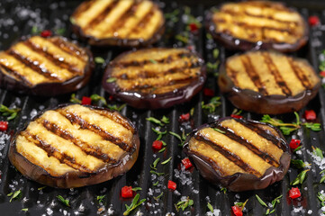 Fried eggplant slices in a grill.